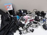 a lot of cameras and other electronics on the table
