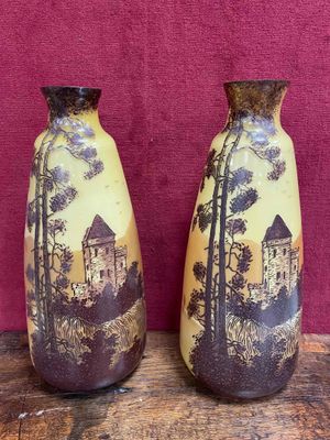 two vases that are sitting on a wooden table
