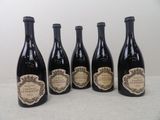 four bottles of wine are lined up on a table