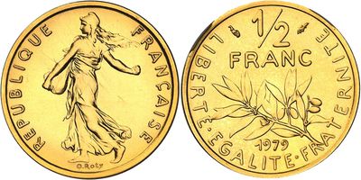 a close up of a gold coin with a woman on it