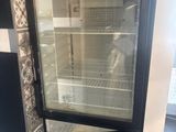 a refrigerator with a glass door inside of it