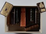 de nombreux livres dans une boîte posée sur une surface blanche