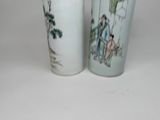 two vases that are sitting on a table