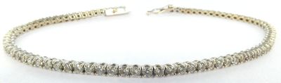 a close up of a silver bracelet on a white background
