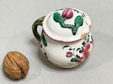 a nut and a teapot sitting on a table