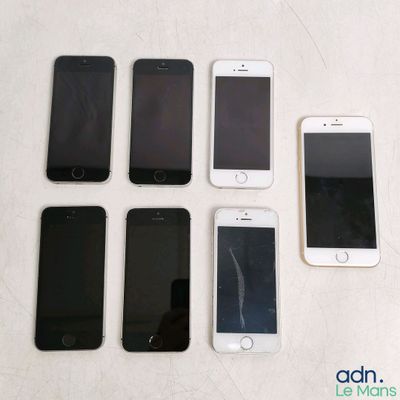 several cell phones are lined up in a row on a table