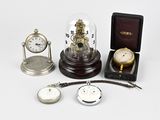 many different types of clocks on display in a case