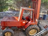 a red tractor that is parked on the side of the road