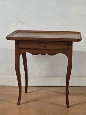 an image of a small wooden table with a drawer on it