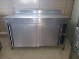 a stainless steel sink in a kitchen with a tiled floor