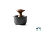 a black cup with a wooden handle on a white background