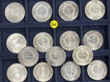 a lot of silver coins in a black box