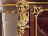 a gold statue on top of a display case