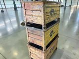 three wooden crates stacked on top of each other in a warehouse