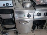 a kitchen with a stove, oven, and a sink