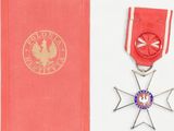 an image of a red book with a medal and a red case