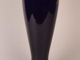 a blue vase with a gold design on it