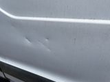 a white van with holes on the side of it