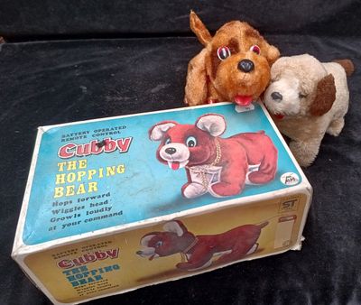 two stuffed animals that are sitting next to a box