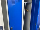 two blue lockers in a room with one open and the other closed