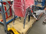 many chairs that are sitting on a pallet in a warehouse