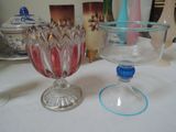 a glass bowl sitting next to a glass bowl on a table