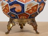 a vase that is sitting on a stand on a table