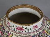 a close up of a vase with a flower design on it
