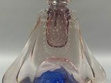 a glass figurine of a woman with a hat on her head