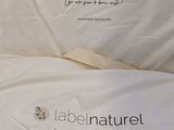 two pillows that have labels on them on them