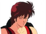 an image of a man with a red shirt and a black vest