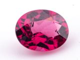 a close up of a pink diamond on a white surface