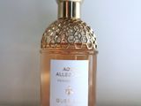 an image of a bottle of perfume sitting on a white surface
