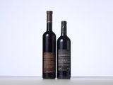 two bottles of wine sitting next to each other on a table