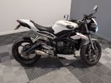 a white and black motorcycle parked on a checkered floor