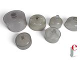 a group of glass containers with lids on a white surface