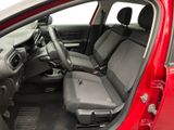 the interior of a red car with two seats and a steering wheel