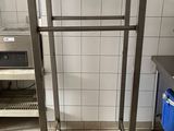 a metal rack in the middle of a kitchen