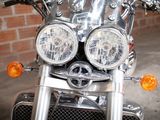 a close up of a motorcycle with a brick wall in the background