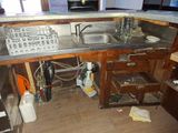a kitchen with a sink and a keyboard on the counter
