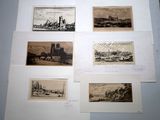 four old black and white pictures of ships on display in a room