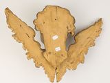 wooden sculpture of a bird with wings on a white surface