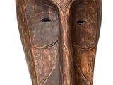 un masque en bois accroché au mur