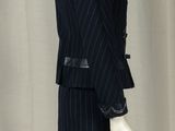 a mannequin wearing a suit and tie on a mannequin stand