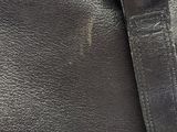 a black purse with a metal buckle on it