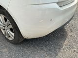 a white car that is parked on the side of the road