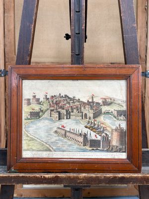 tableau représentant une vue de ville, posé sur un chevalet à cadre en bois