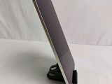 a tablet that is sitting on a stand on a table