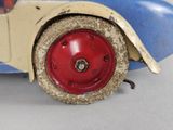 a small toy car with a red wheel on a white surface