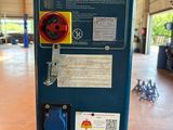 a blue machine that has a red button on it